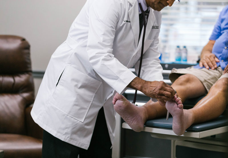 Dr. Anderson examining a patient's feet
